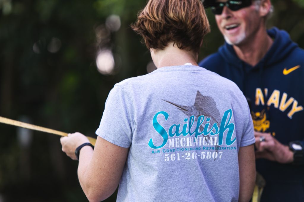lady with sailfish mechanical logo tshirt on the back