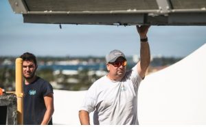 man guiding large ac unit as it's moved